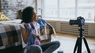 Woman filming herself with a camera on tripod