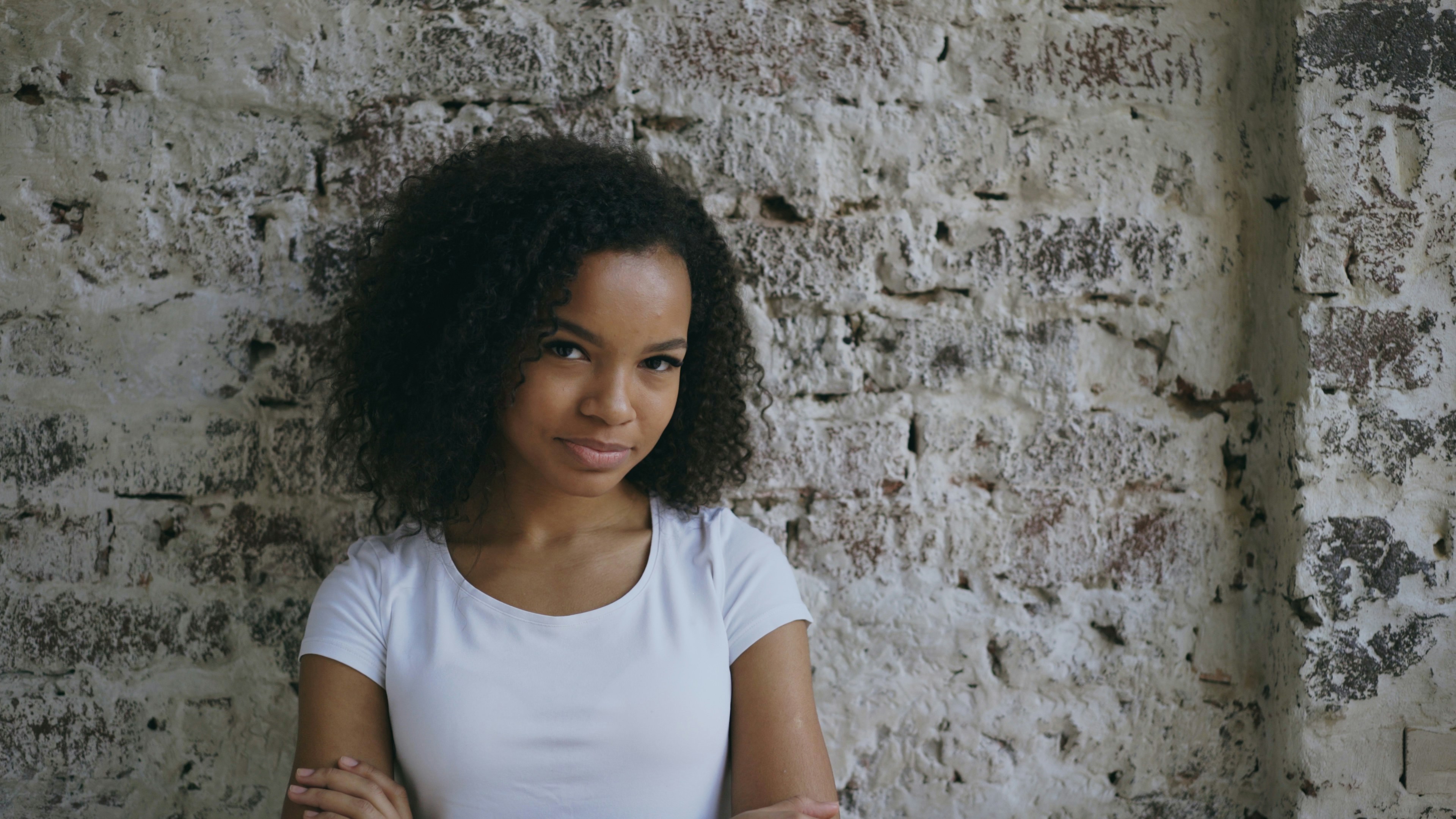 Smiling woman against brick wall