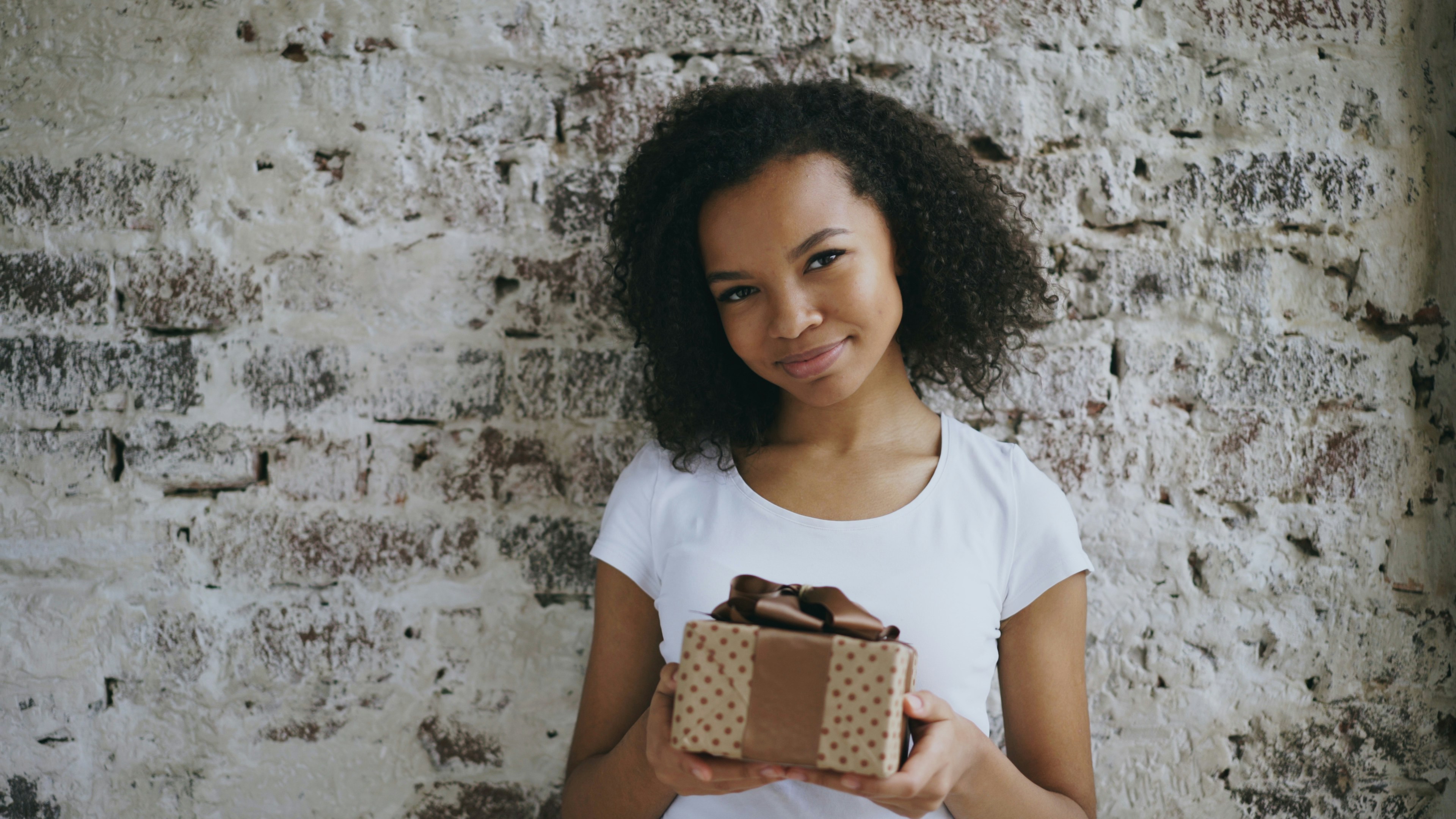 Young woman holding a gift box