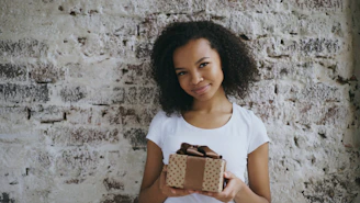 Young woman holding a gift box