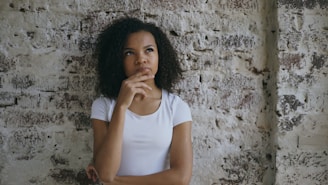 Young woman with hand on chin thinking