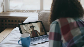 Woman video chatting with a man on laptop.