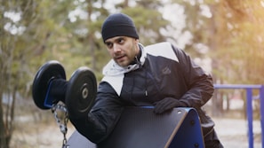 Man lifting weights at outdoor gym