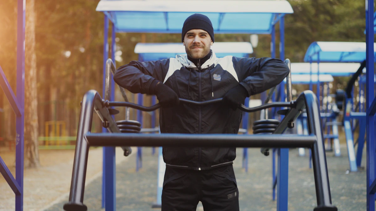 Man exercising outdoors on workout equipment