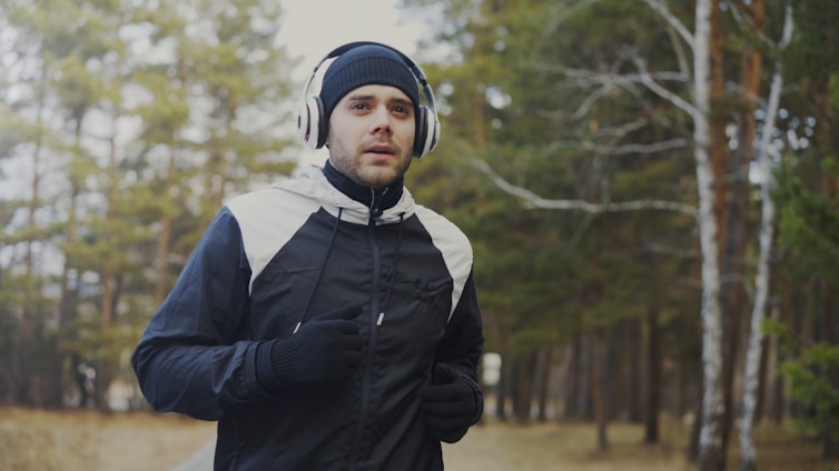 Man running in the woods with headphones