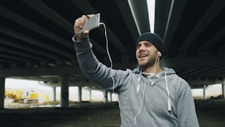 Man in beanie taking a selfie with headphones