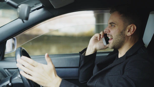 Man talking on phone while driving car
