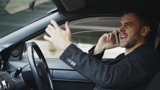 Man talking on phone while driving car