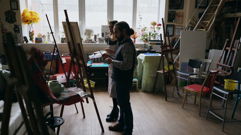 Two artists working in a bright studio
