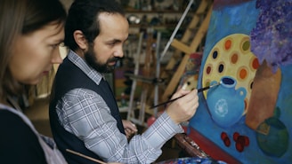 Artist painting a still life with woman observing student.