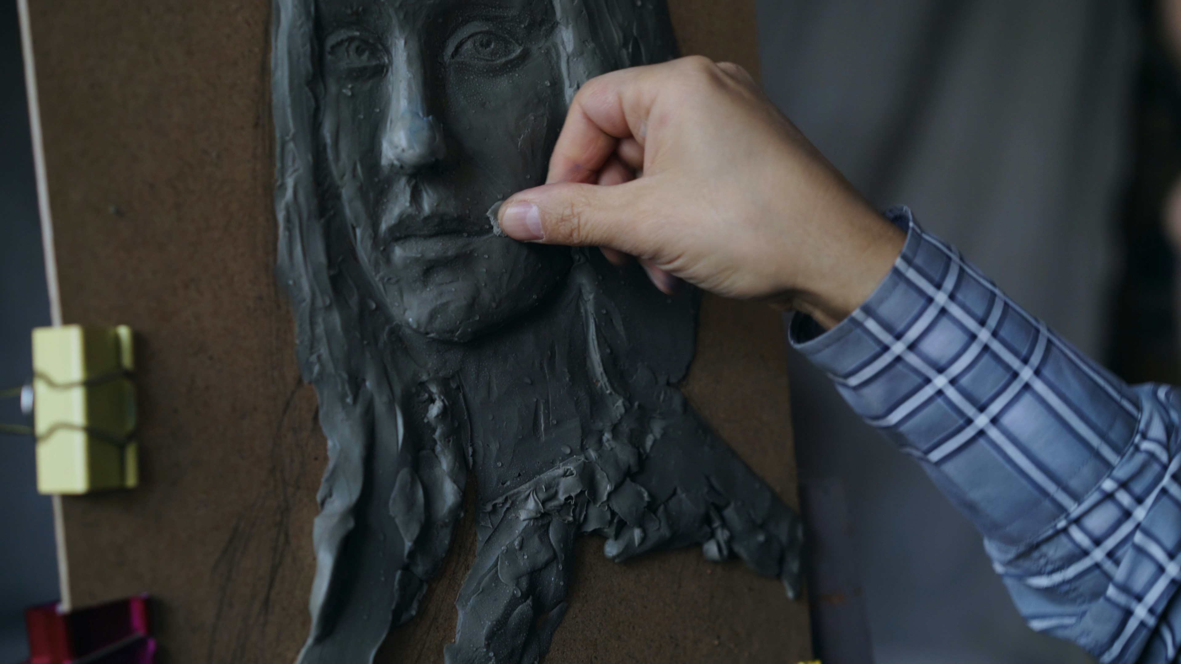 Close-up of sculptor working on sculpture