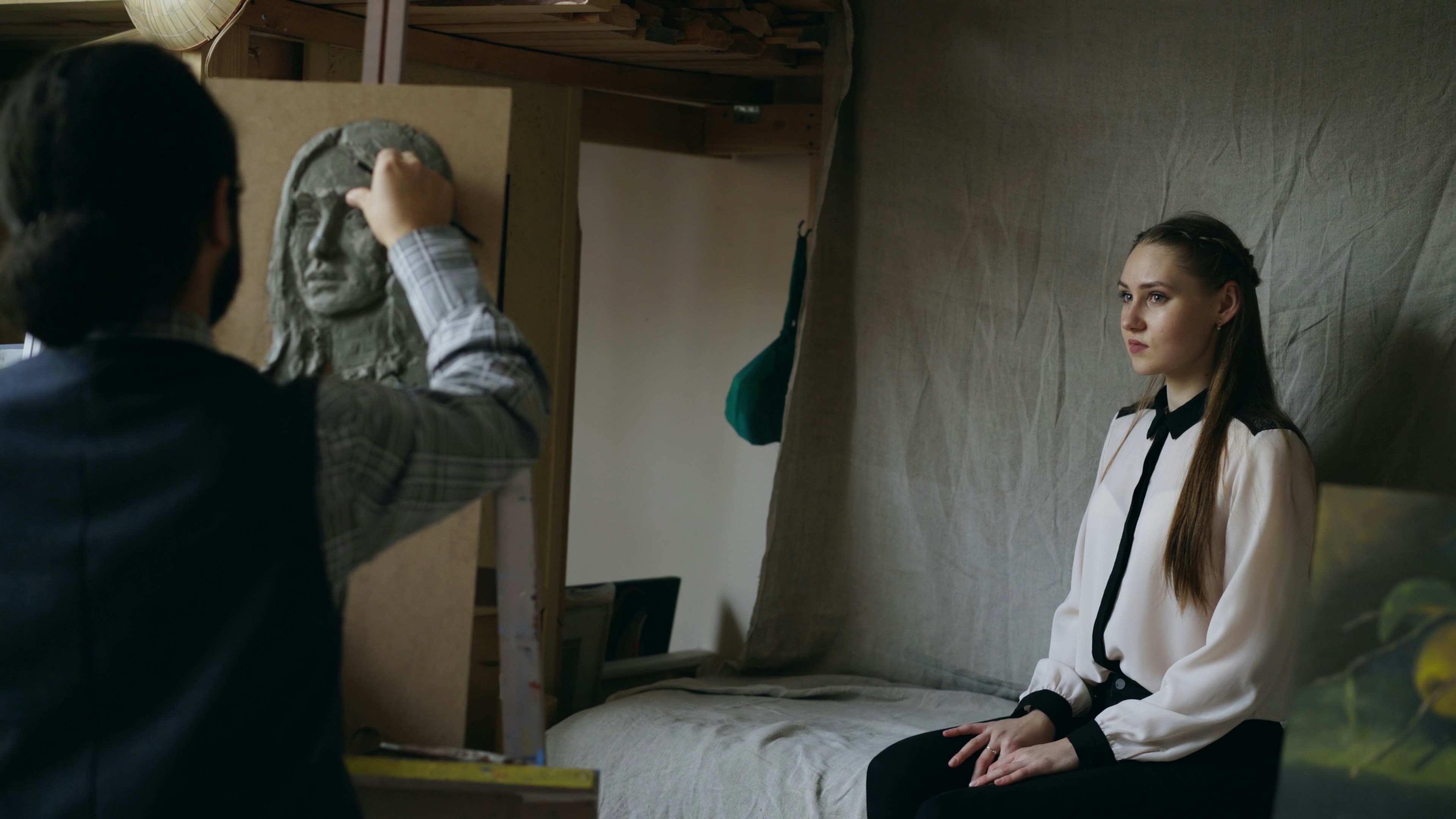 Sculptor working on marble face