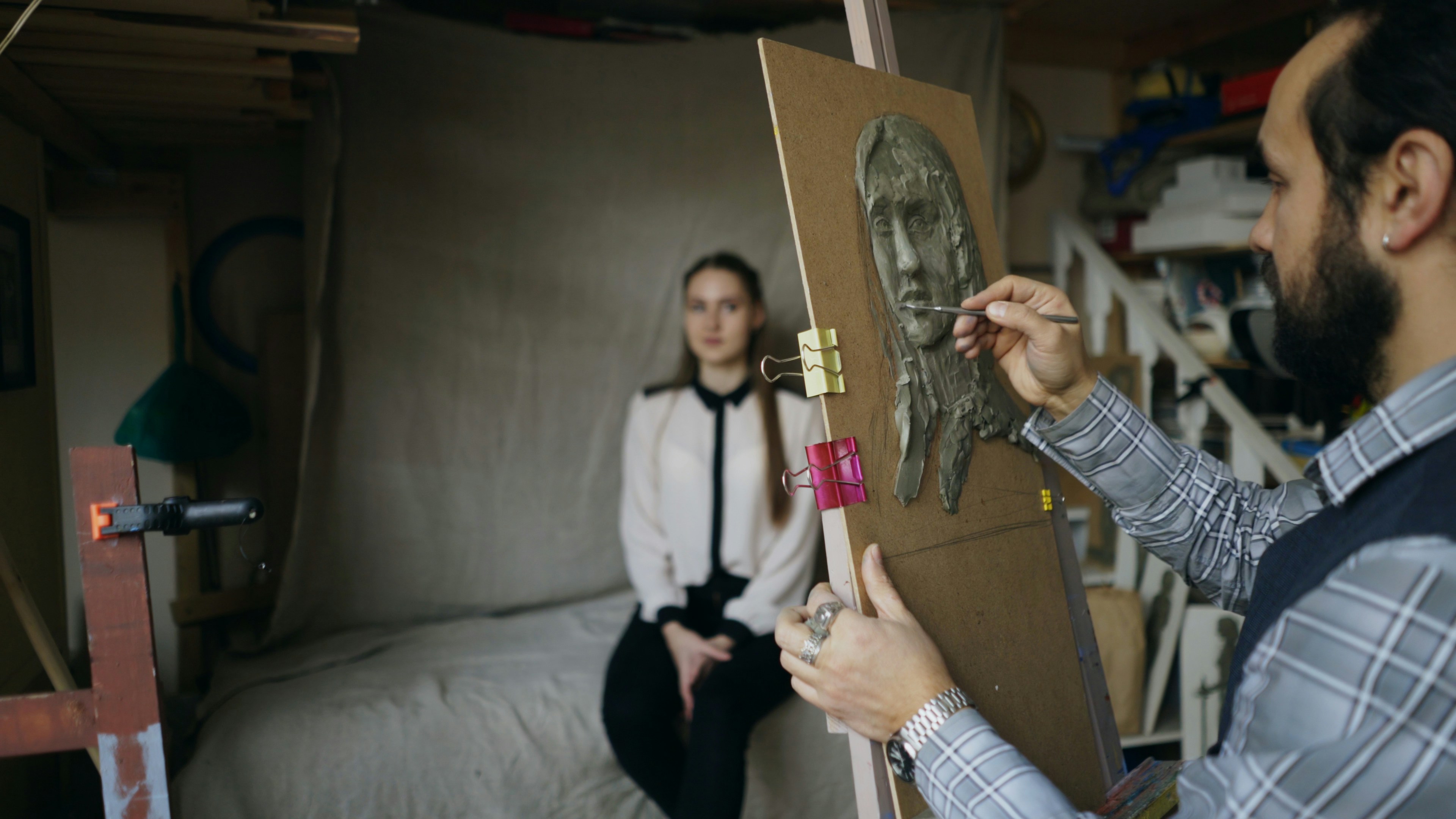 Artist sketching a portrait of a seated woman