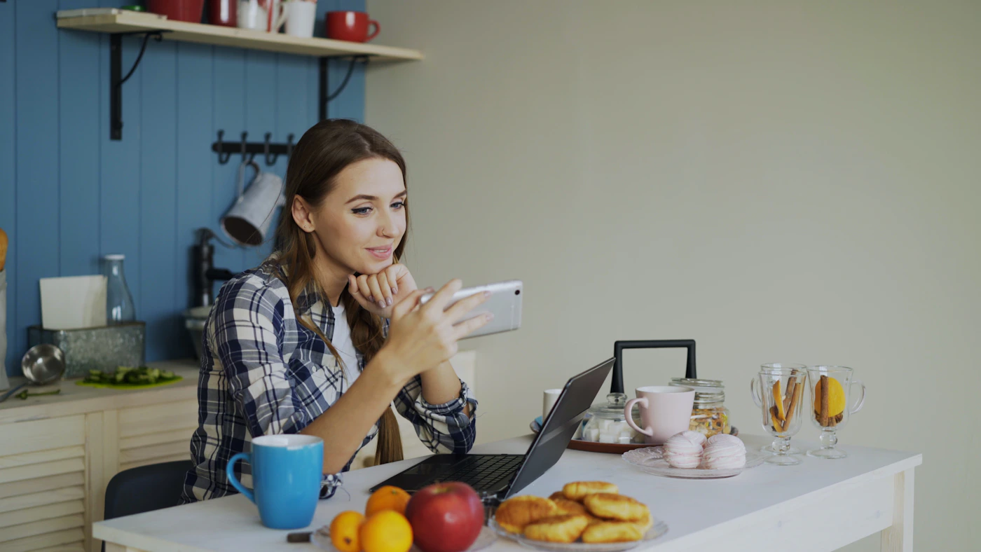 Woman having a video call on her phone at home
