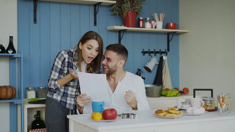 Couple reacting with excitement to a document