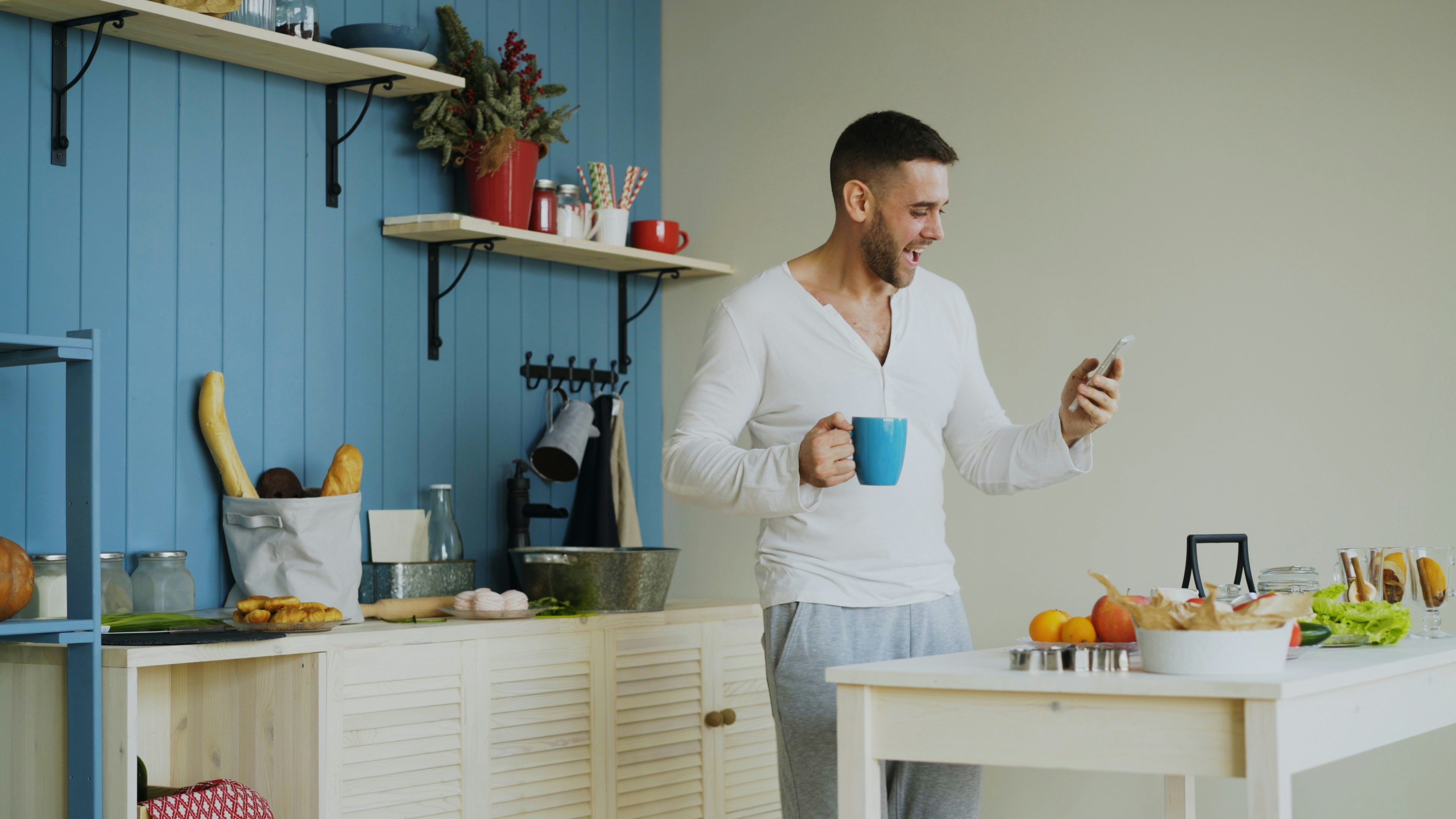 Cheerful man dancing in kitchen