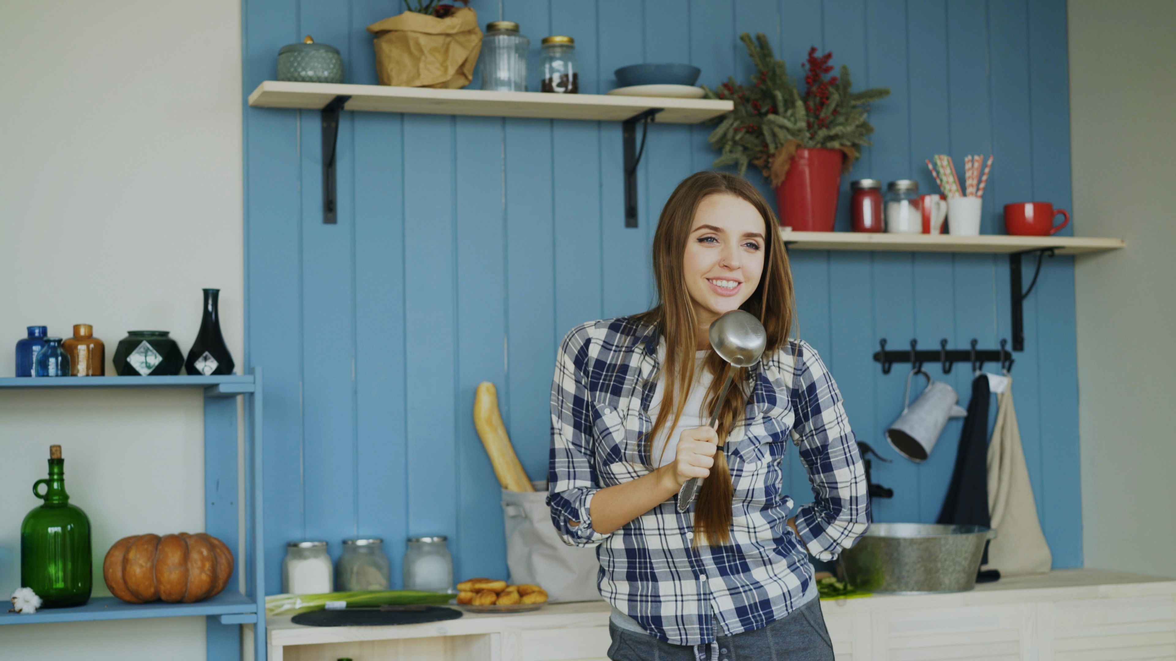 Happy woman cooking in home kitchen
