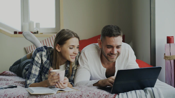 Couple planning finances on a laptop