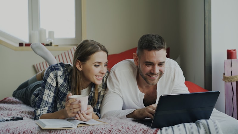 Couple calmly discussing finances at laptop