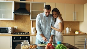 Couple preparing food together in a kitchen