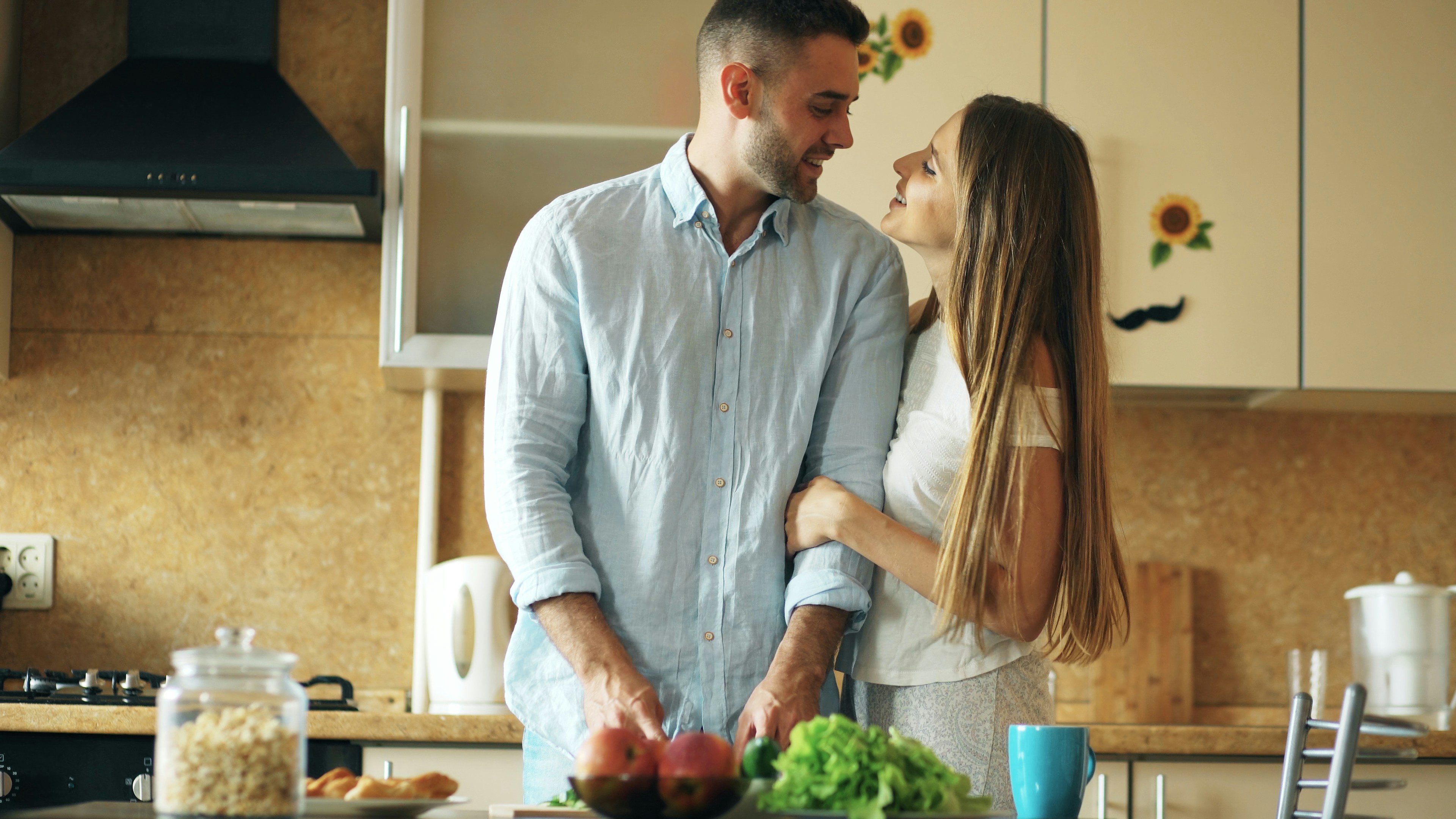 Portrait of loving couple cooking breakfast smiling in the kitchen at home