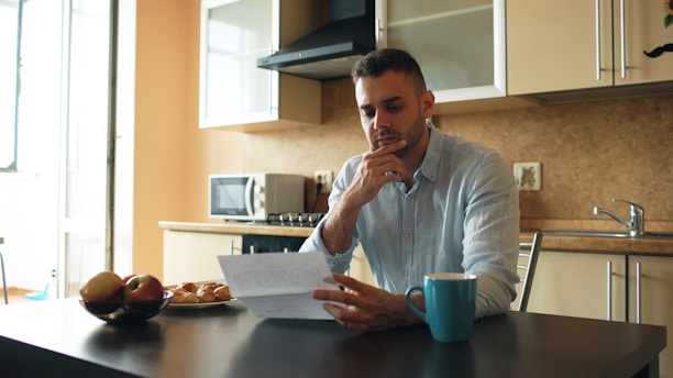 Man reading a document in a kitchen