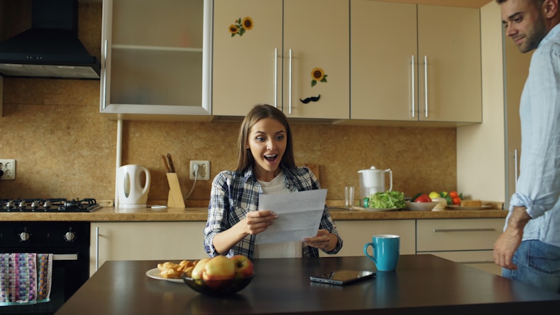 Couple reacts to good news in kitchen