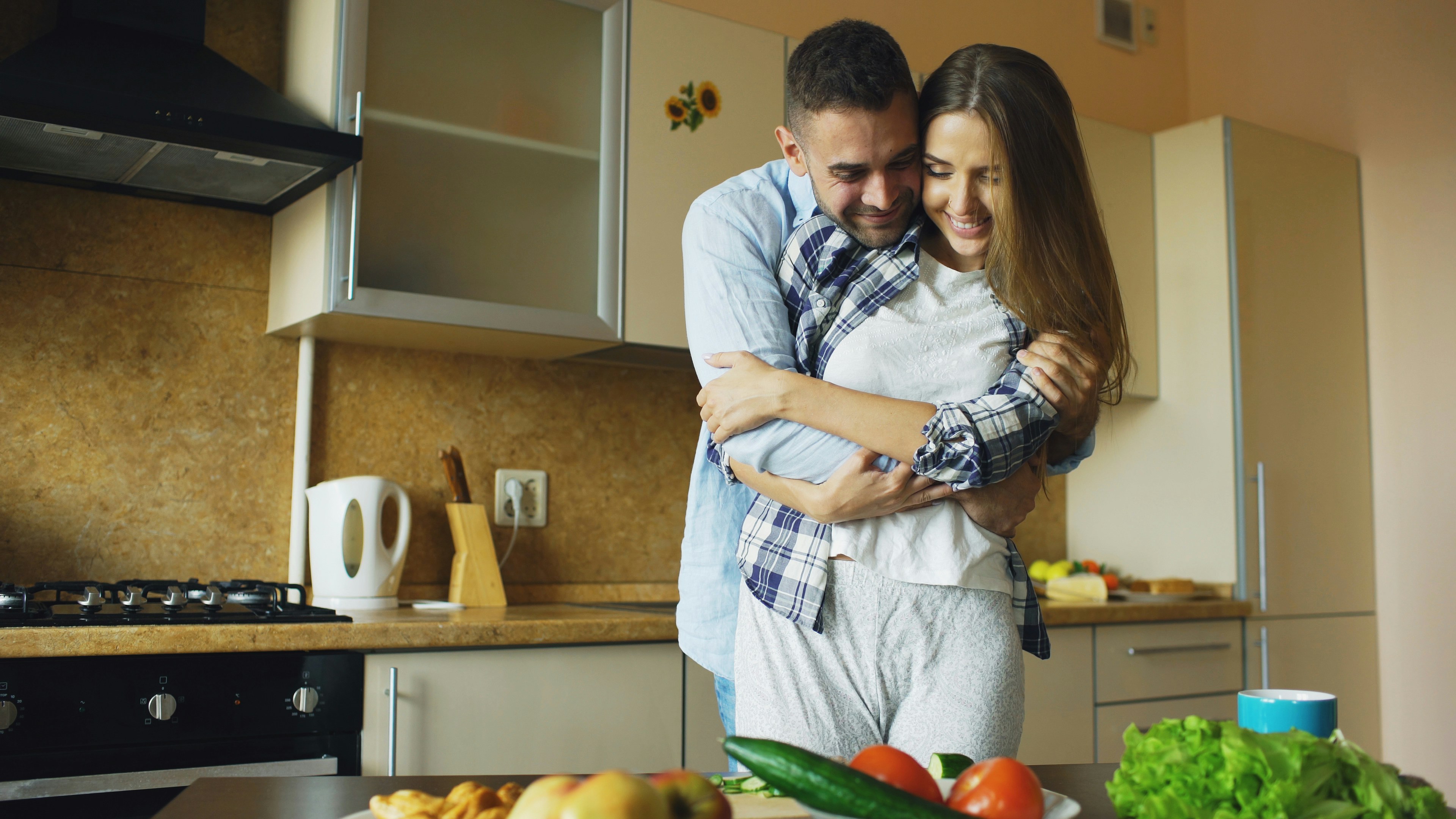 Happy couple cooking breakfast