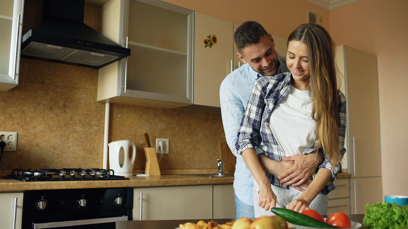 Boyfriend and girlfriend cooking together as an anniversary date