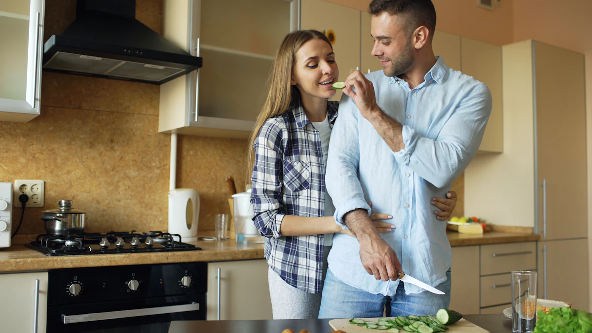 A couple cooking breakfast together in a kitchen