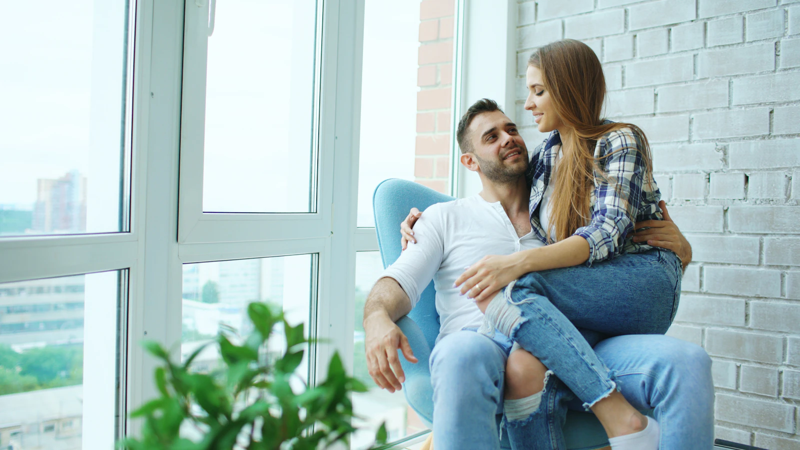 Couple sitting together by a window