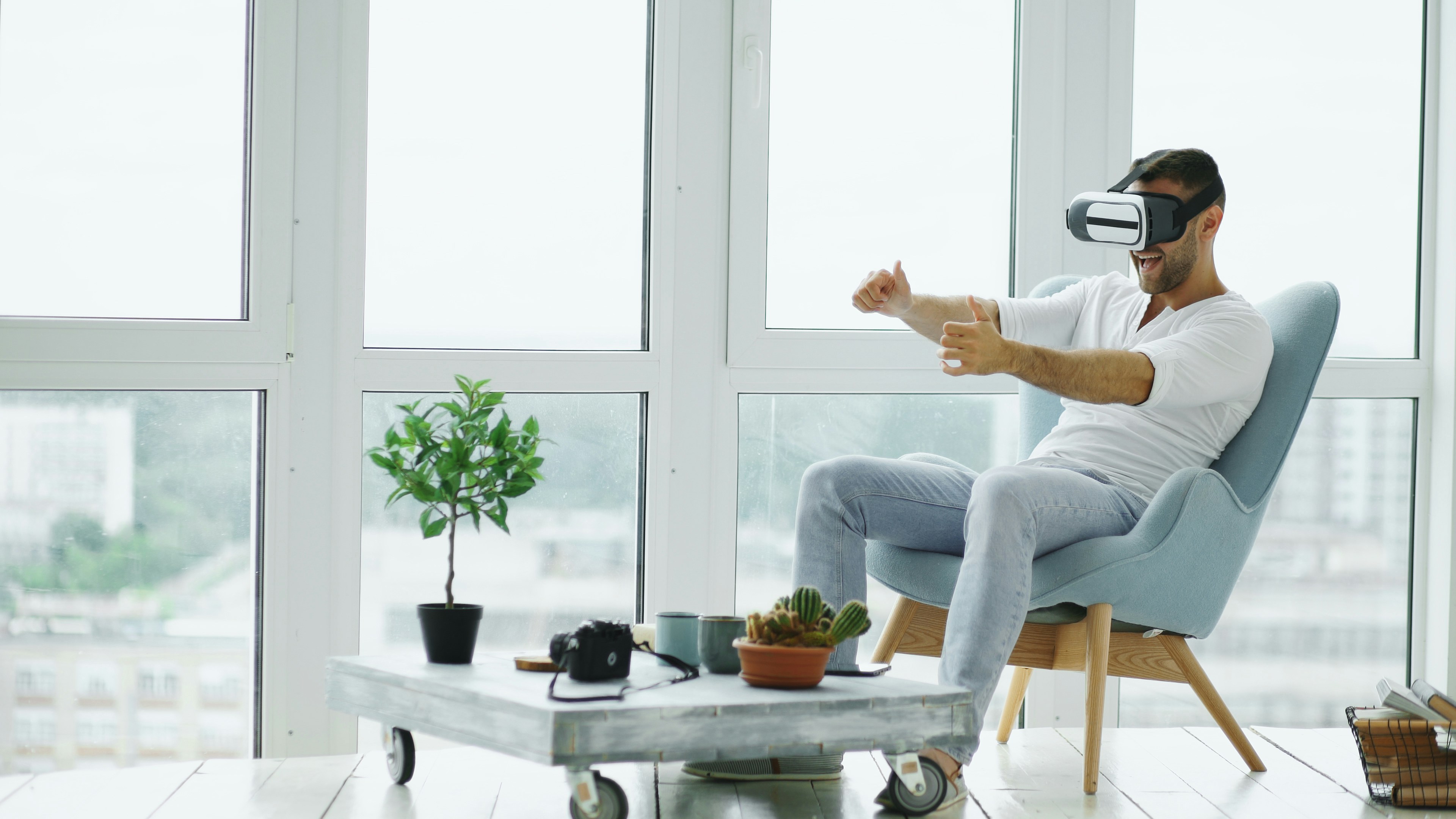 Man playing VR game in armchair