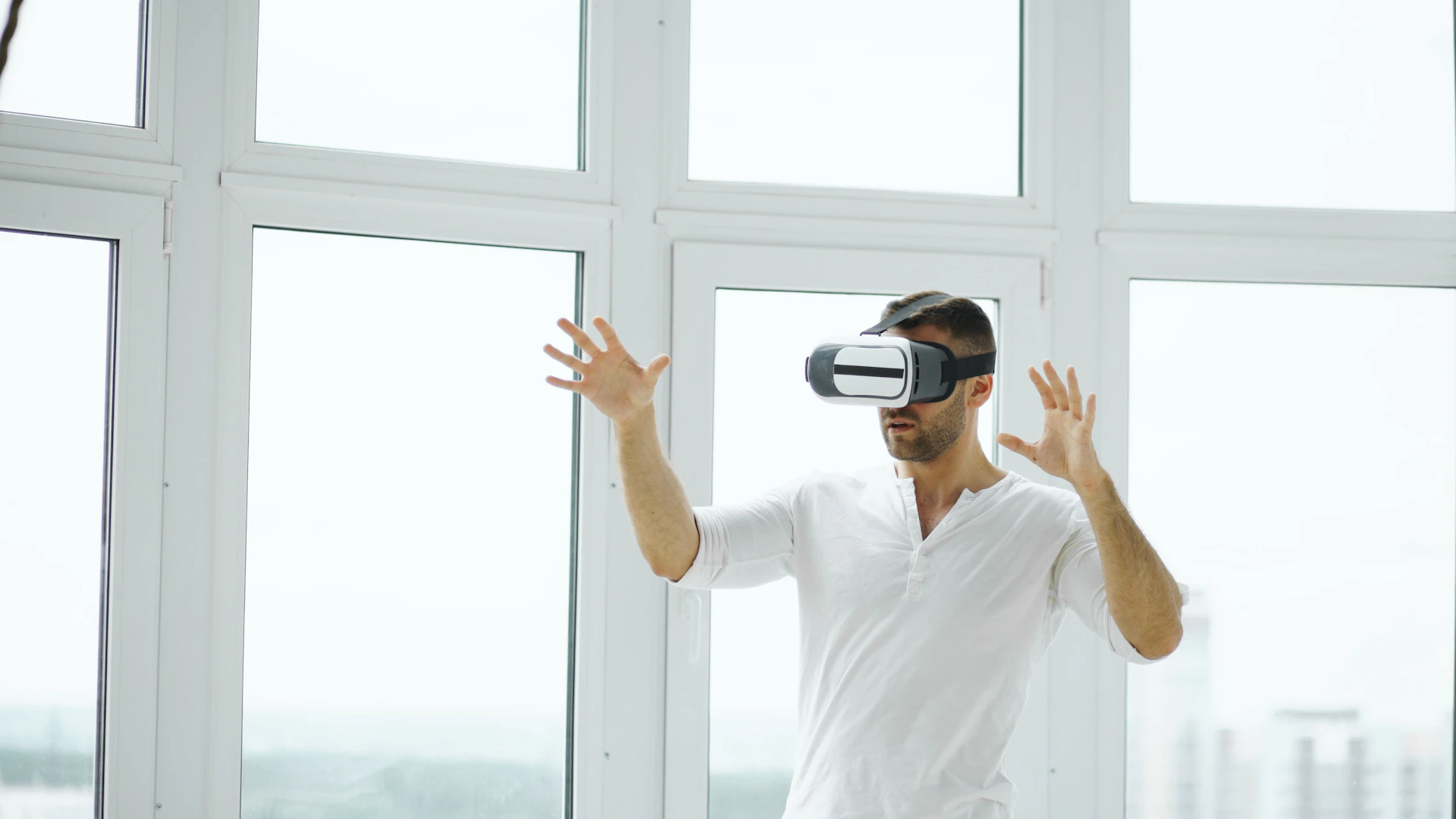 Man wearing vr headset with hands outstretched.