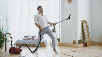 Man playing vacuum cleaner like a guitar