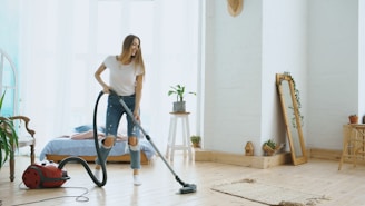 A woman vacuuming a bright, modern living room