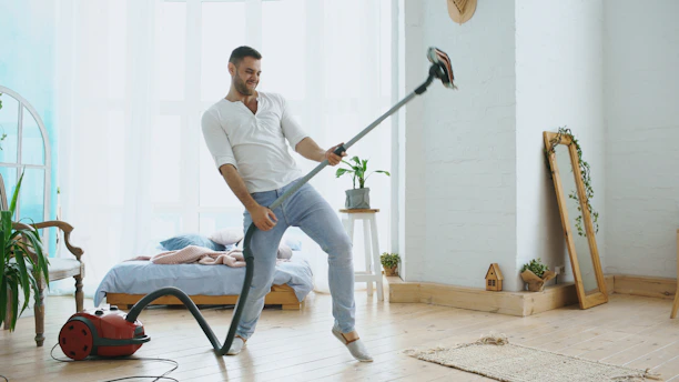 Man playing vacuum cleaner like a guitar