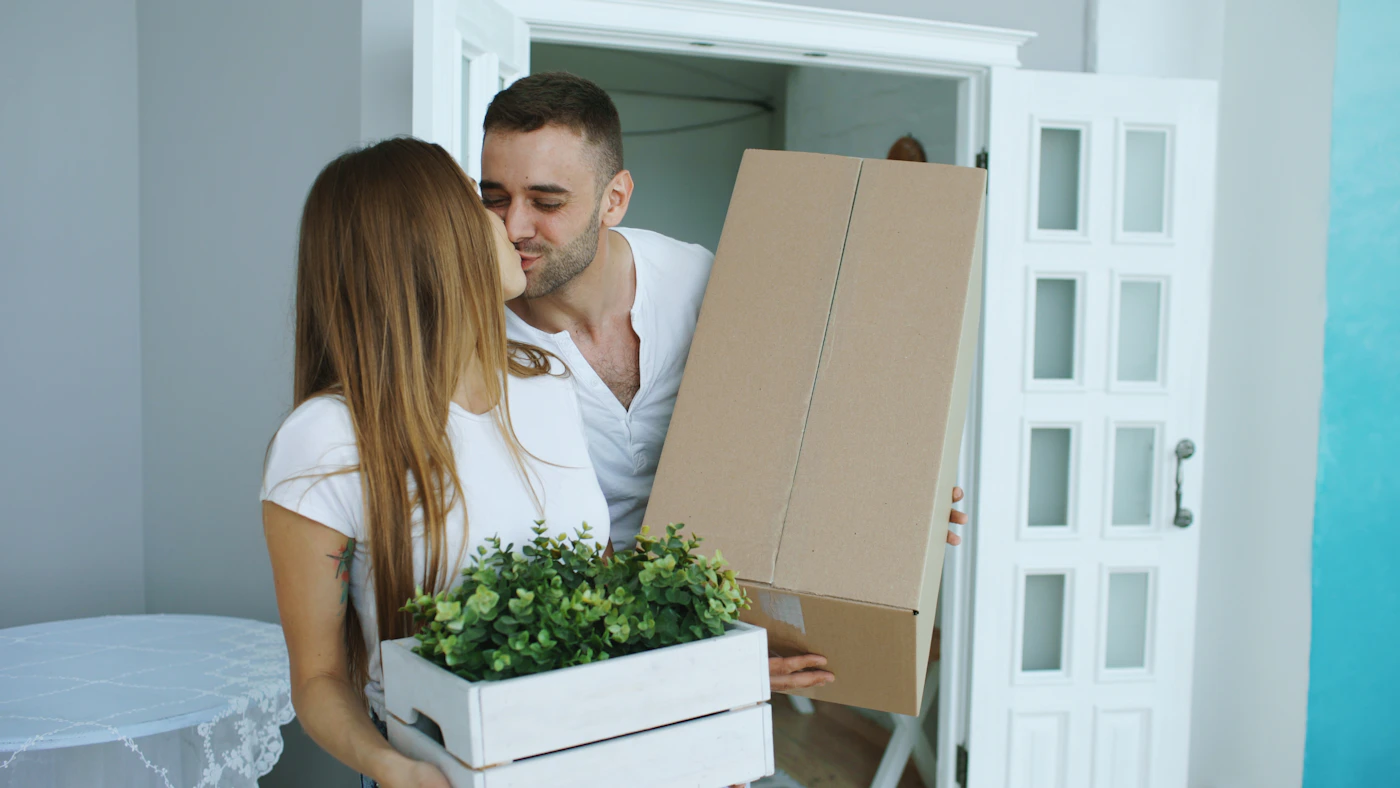 A happy couple moving into a new home with boxes