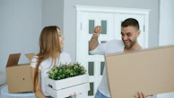 Couple happily moving into a new home