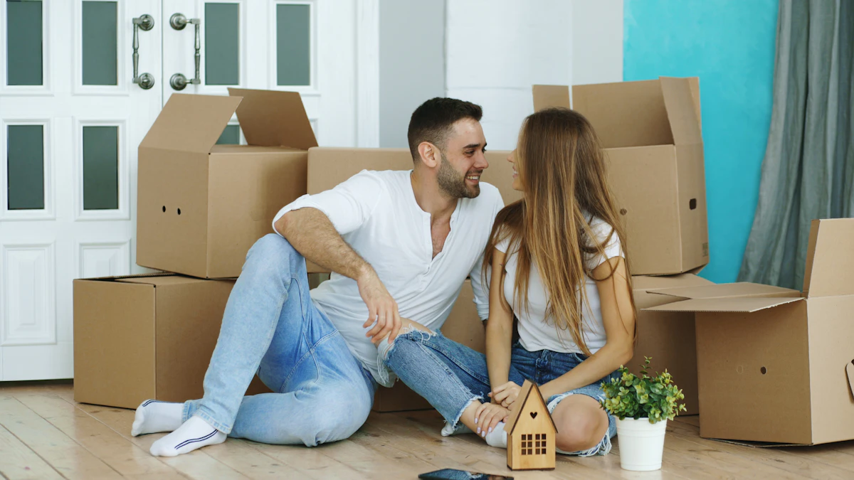 Young couple surrounded by moving boxes in their first home