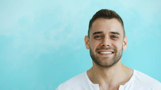 A smiling man with short brown hair and beard.