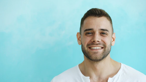 A smiling man with short brown hair and beard.
