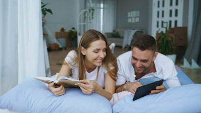 Couple lying in bed reading together