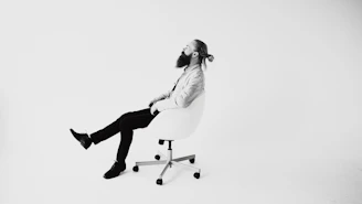 Man with beard sitting in office chair