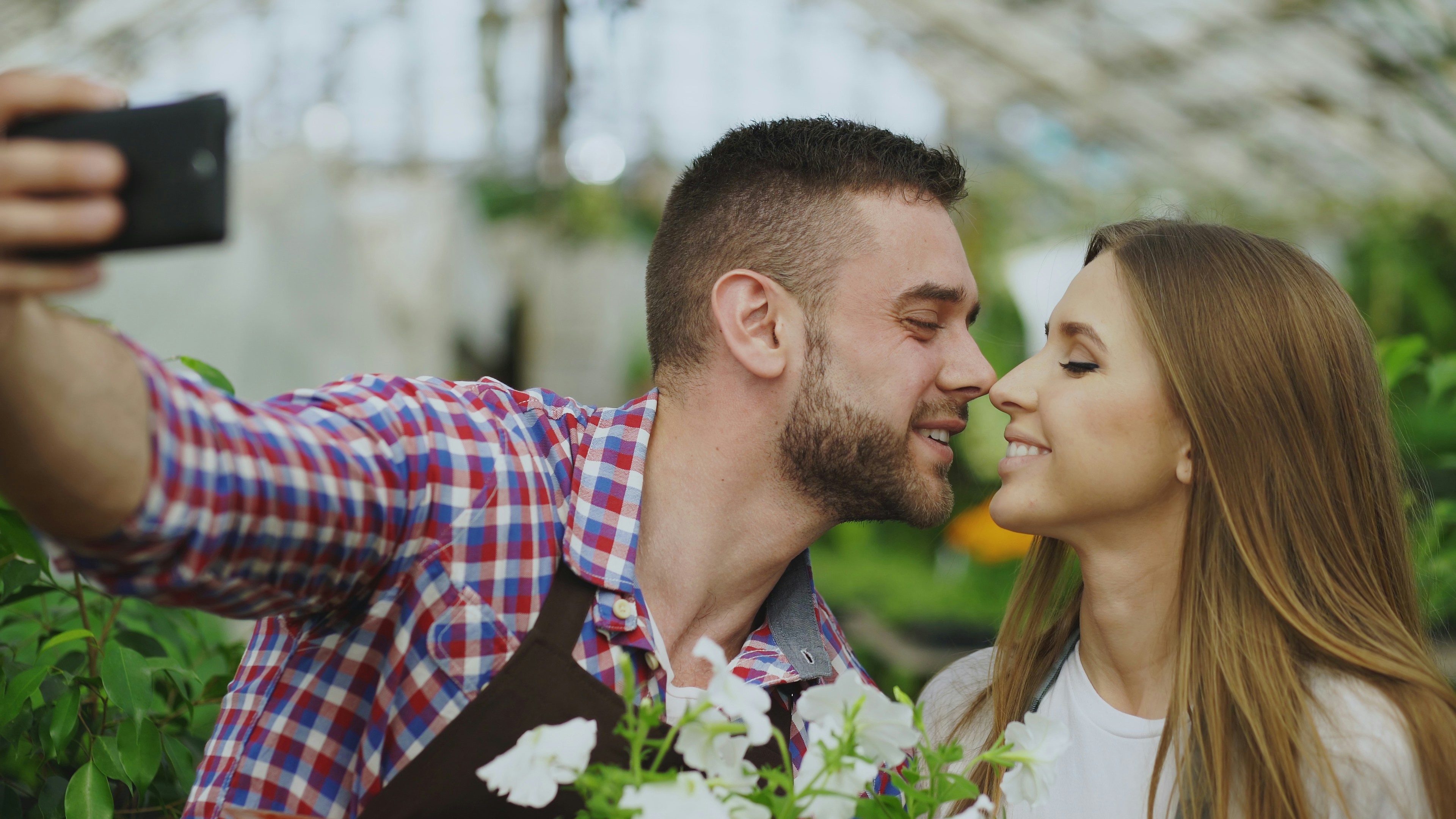 Couple taking a selfie in a greenhouse