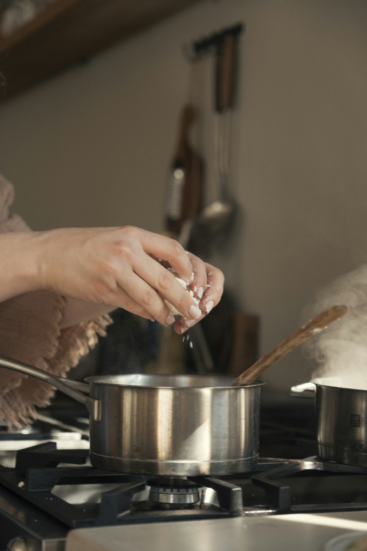 Adding ingredients to a pot for batch cooking meals for one