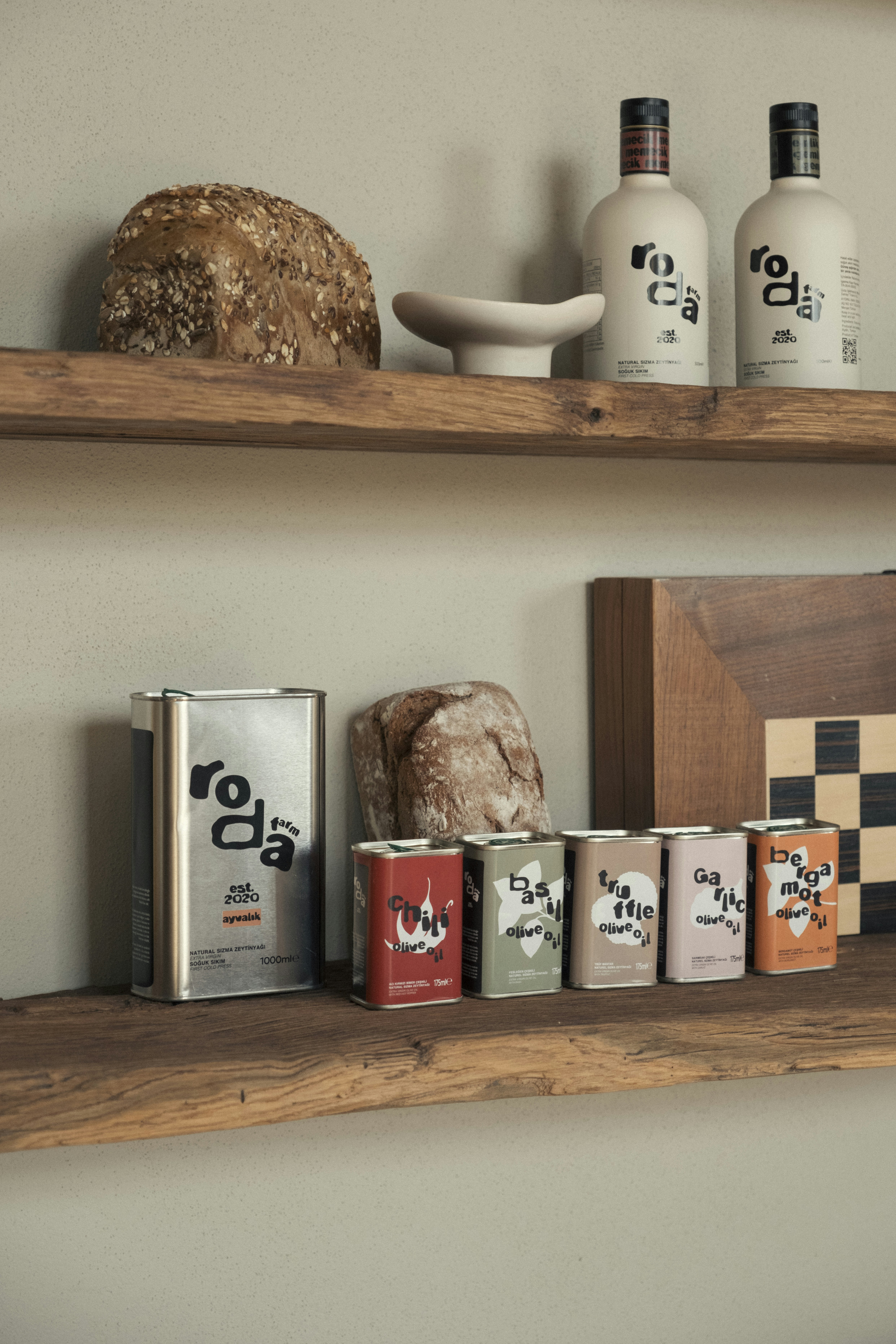Bottles and cans of olive oil with bread.