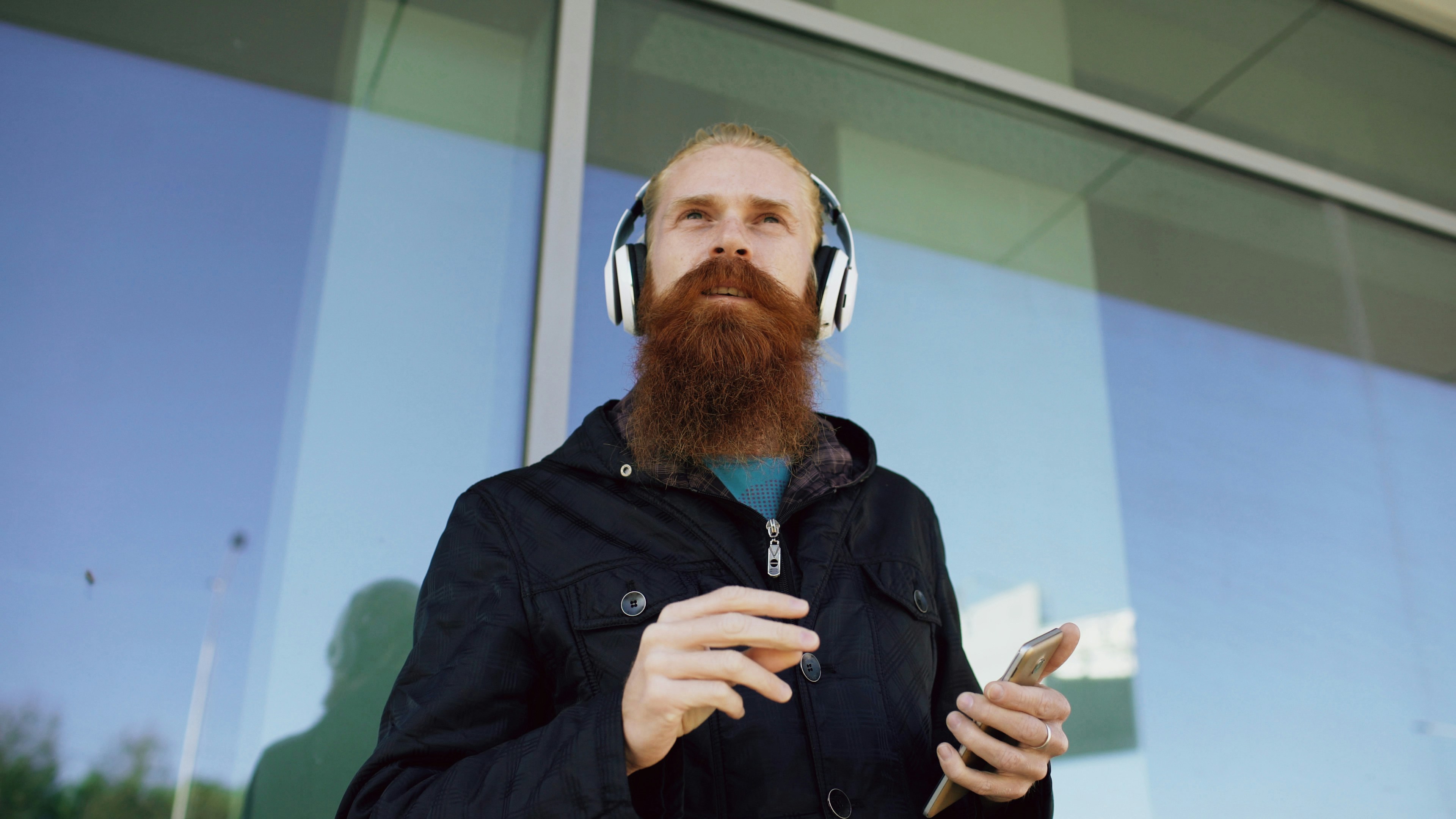 Man with beard wearing headphones listening to music