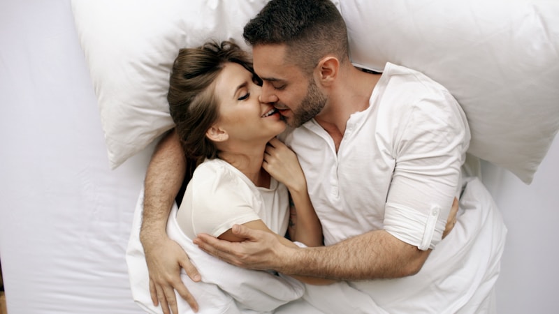 Passionate kiss in bed