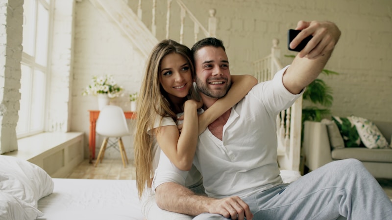 Cheerful couple selfie indoors