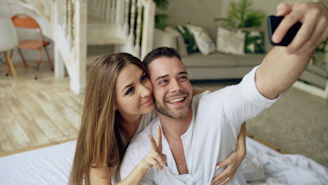Couple taking a selfie in bed